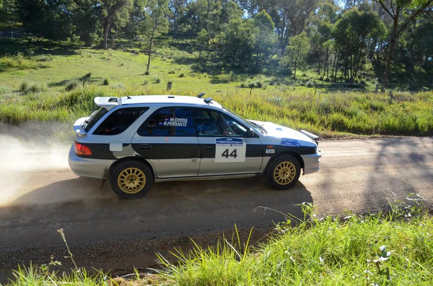 Subaru Impreza kicking up dust on a gravel rally stage in 2026