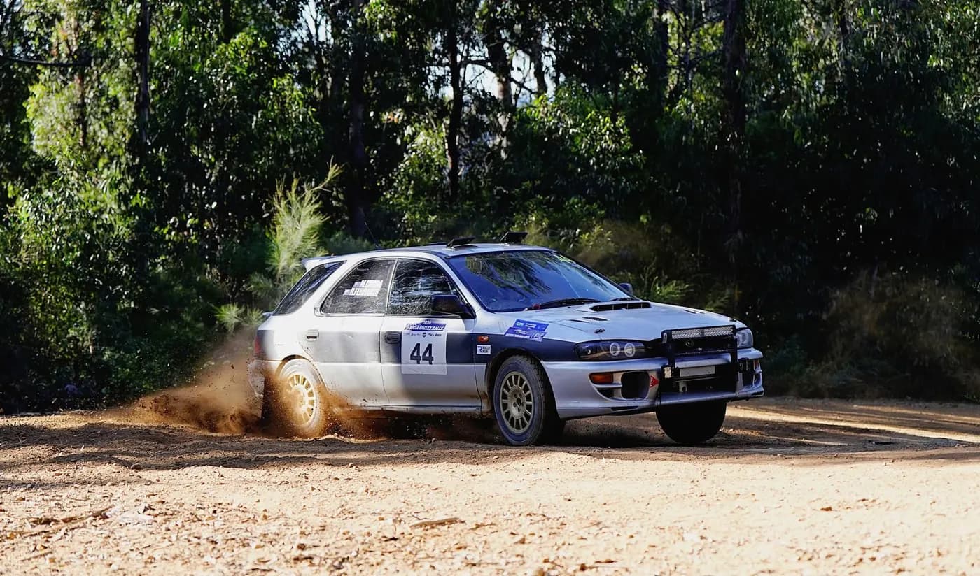 Michael Chora sliding the #44 Subaru Impreza through a gravel corner, 2026 season