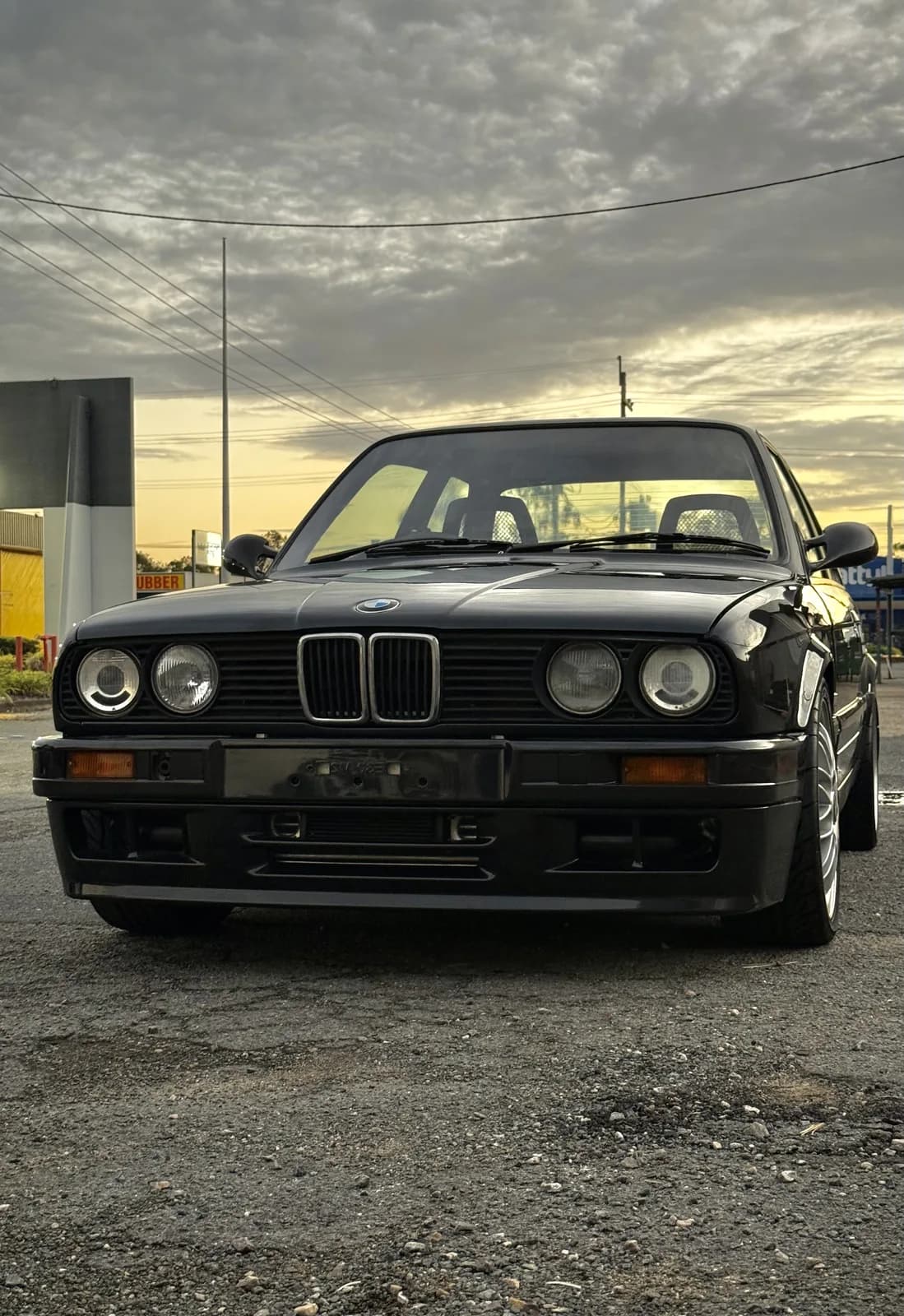 A BMW E30 in golden-hour light on the Brisbane build trip