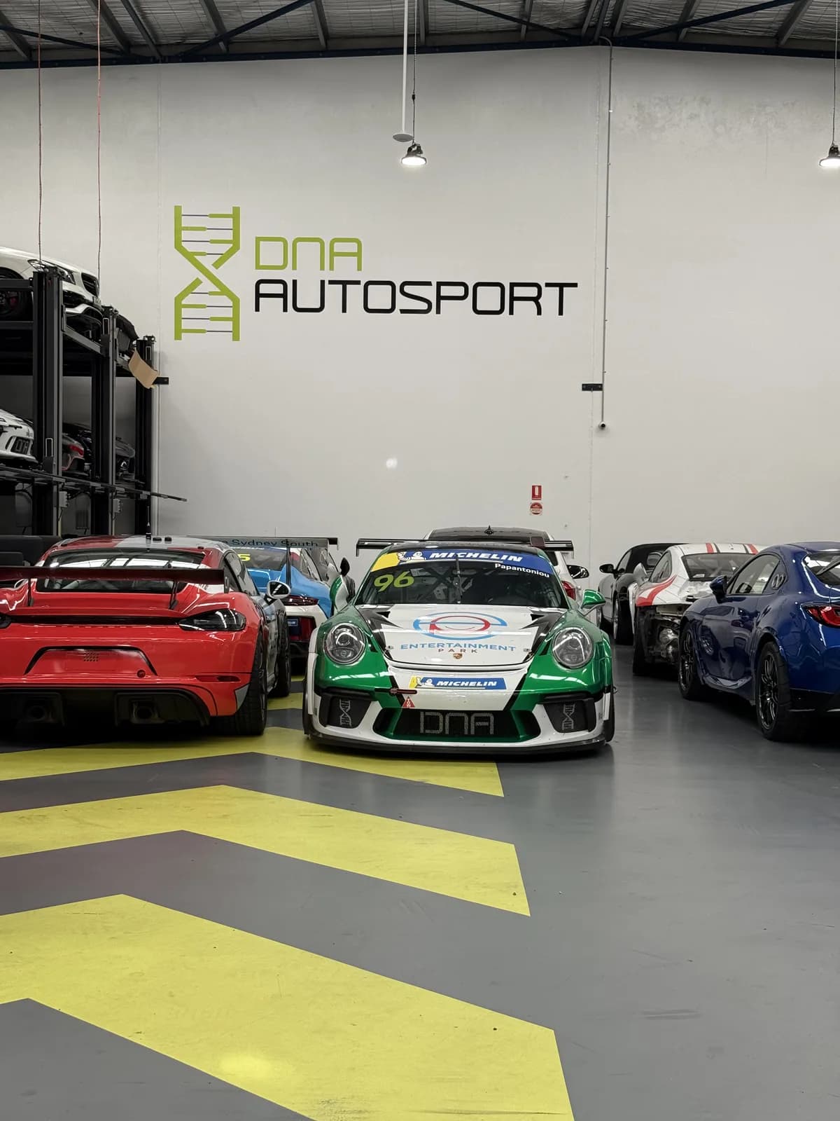 Race cars inside the DNA Autosport workshop