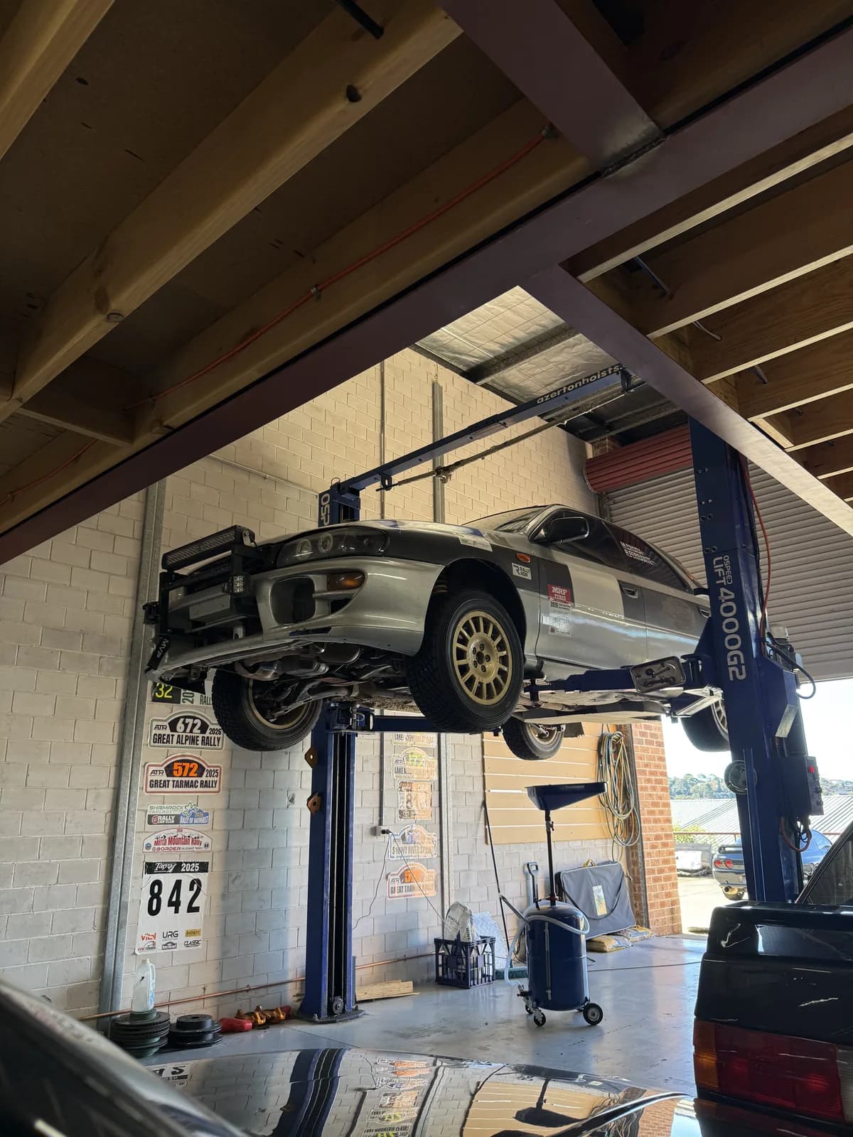 The Shakewell Racing Subaru Impreza up on the hoist for preparation