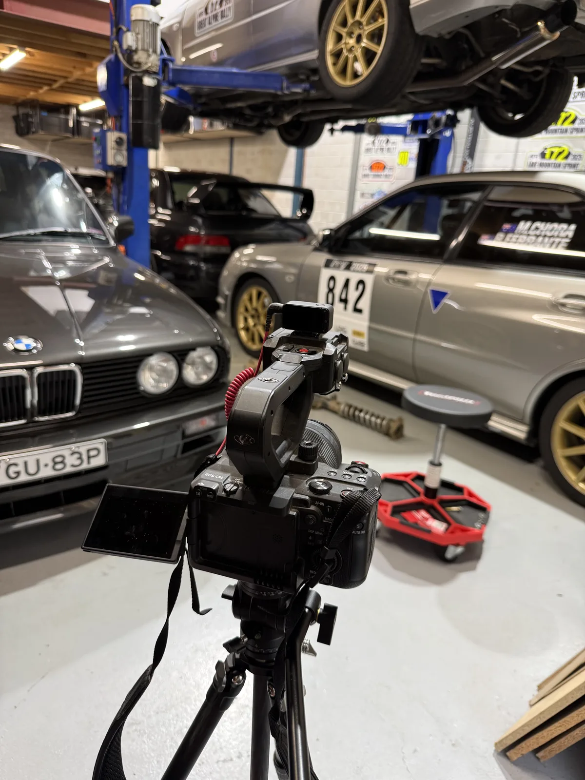 Filming the rally cars during a workshop prep session