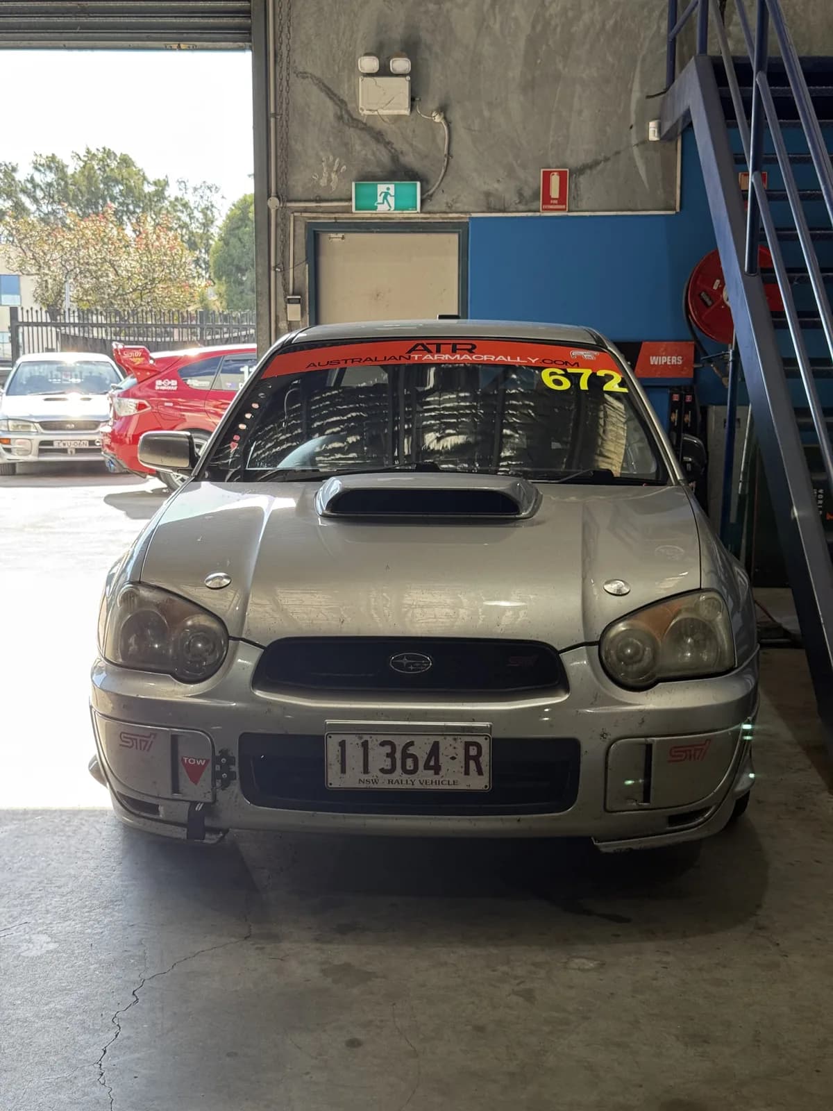 Betsy, the Shakewell Racing Subaru WRX STI, back in the workshop with its ATR 672 windscreen banner the day after the Snowy River Sprint