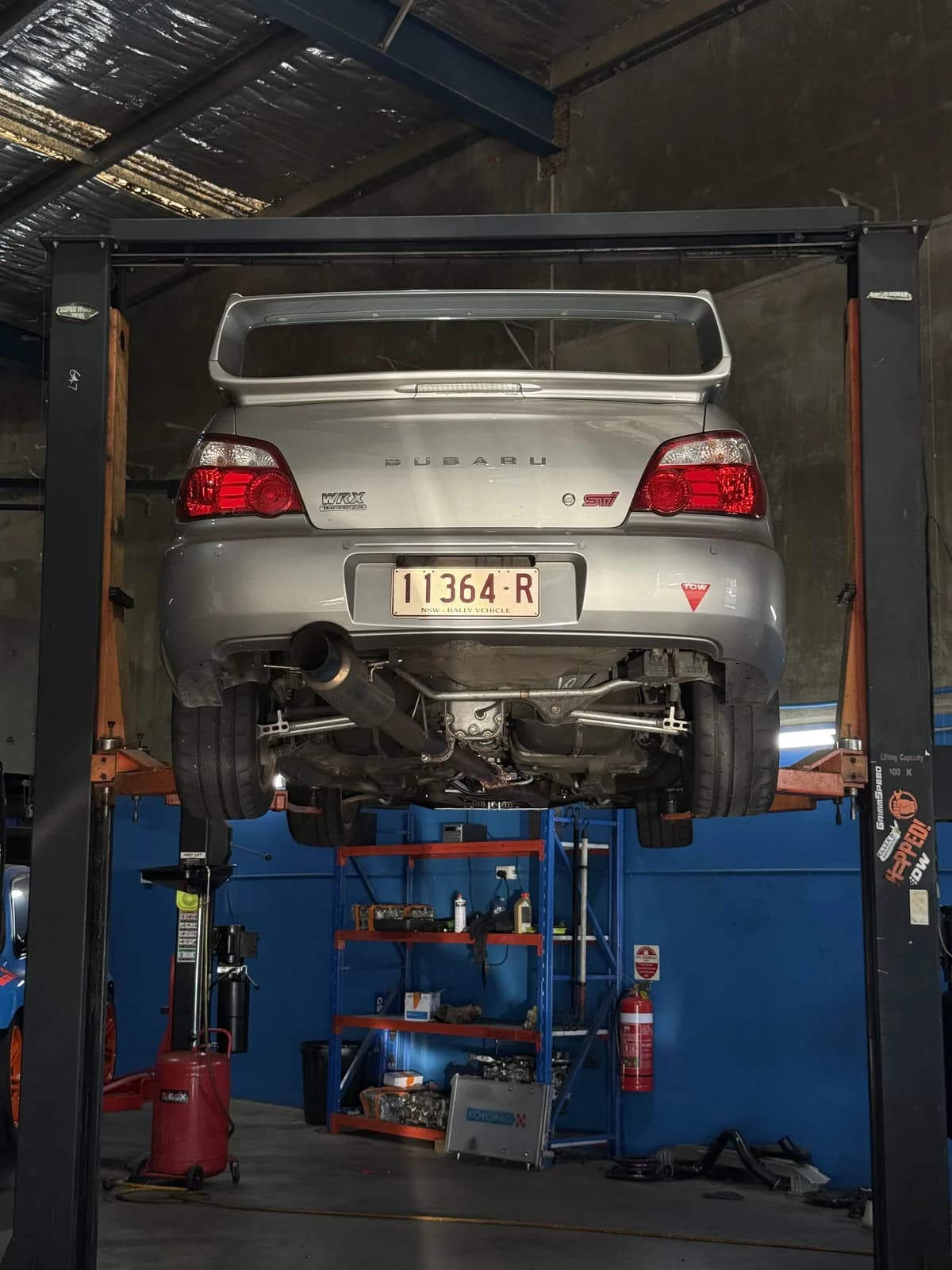 Betsy, the Shakewell Racing Subaru WRX STI, up on the hoist in the workshop