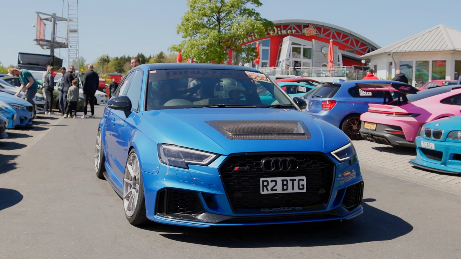 A blue Audi RS3 among the cars gathered at the Nürburgring