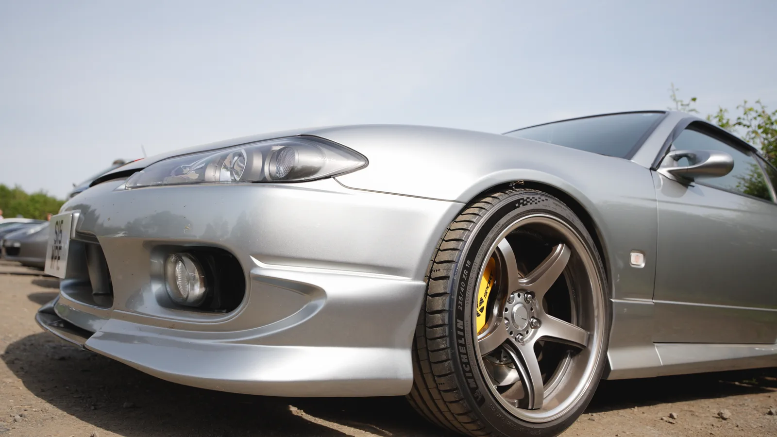 A silver Nissan Silvia S15 on bronze wheels at the Nürburgring