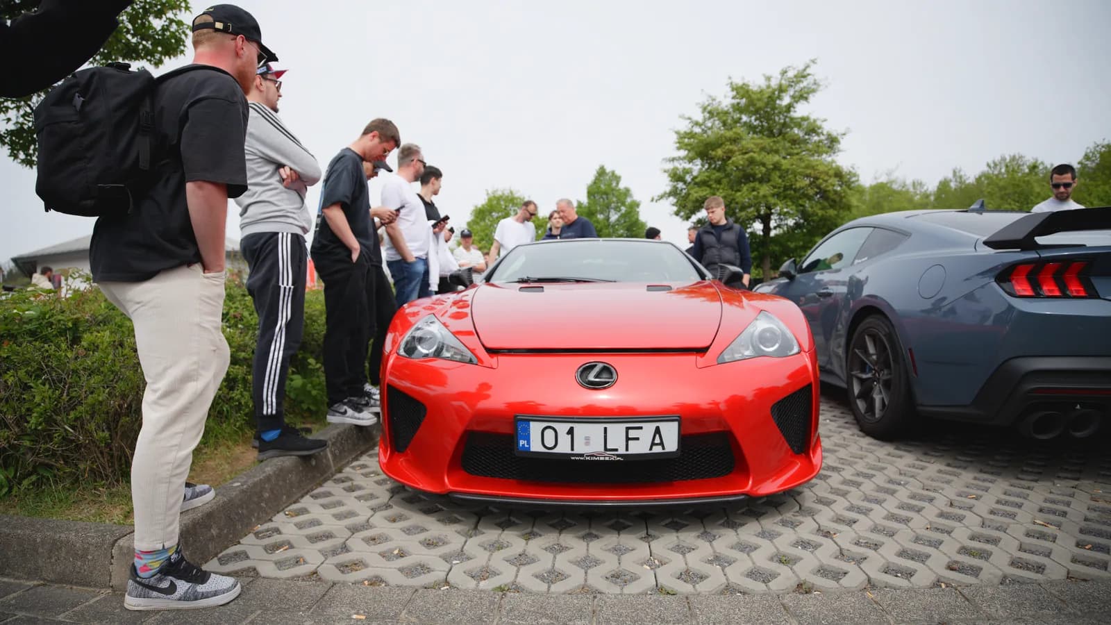 A red Lexus LFA drawing a crowd at the Nürburgring