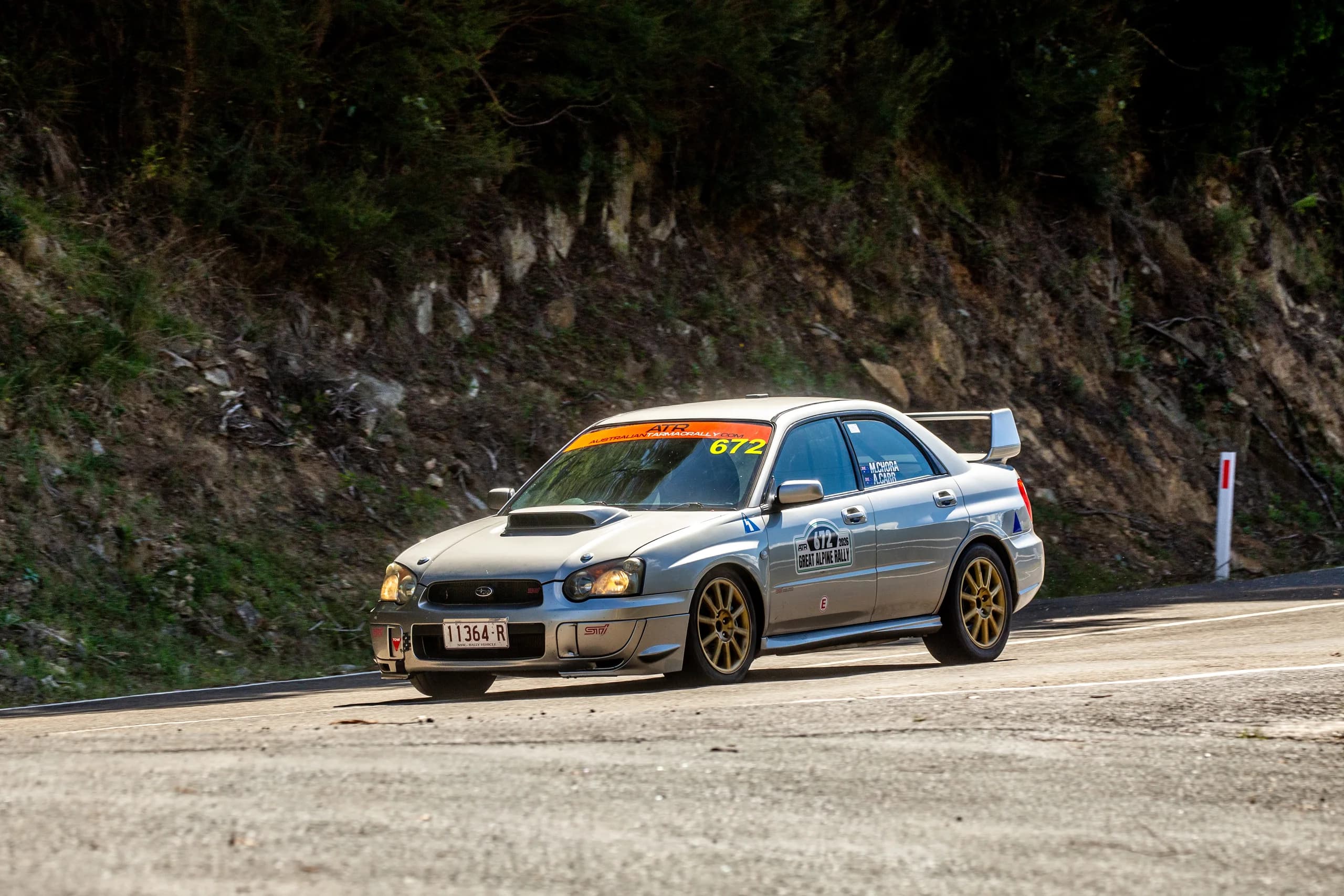The WRX STI stopped on the verge of an alpine road at the Great Alpine Rally