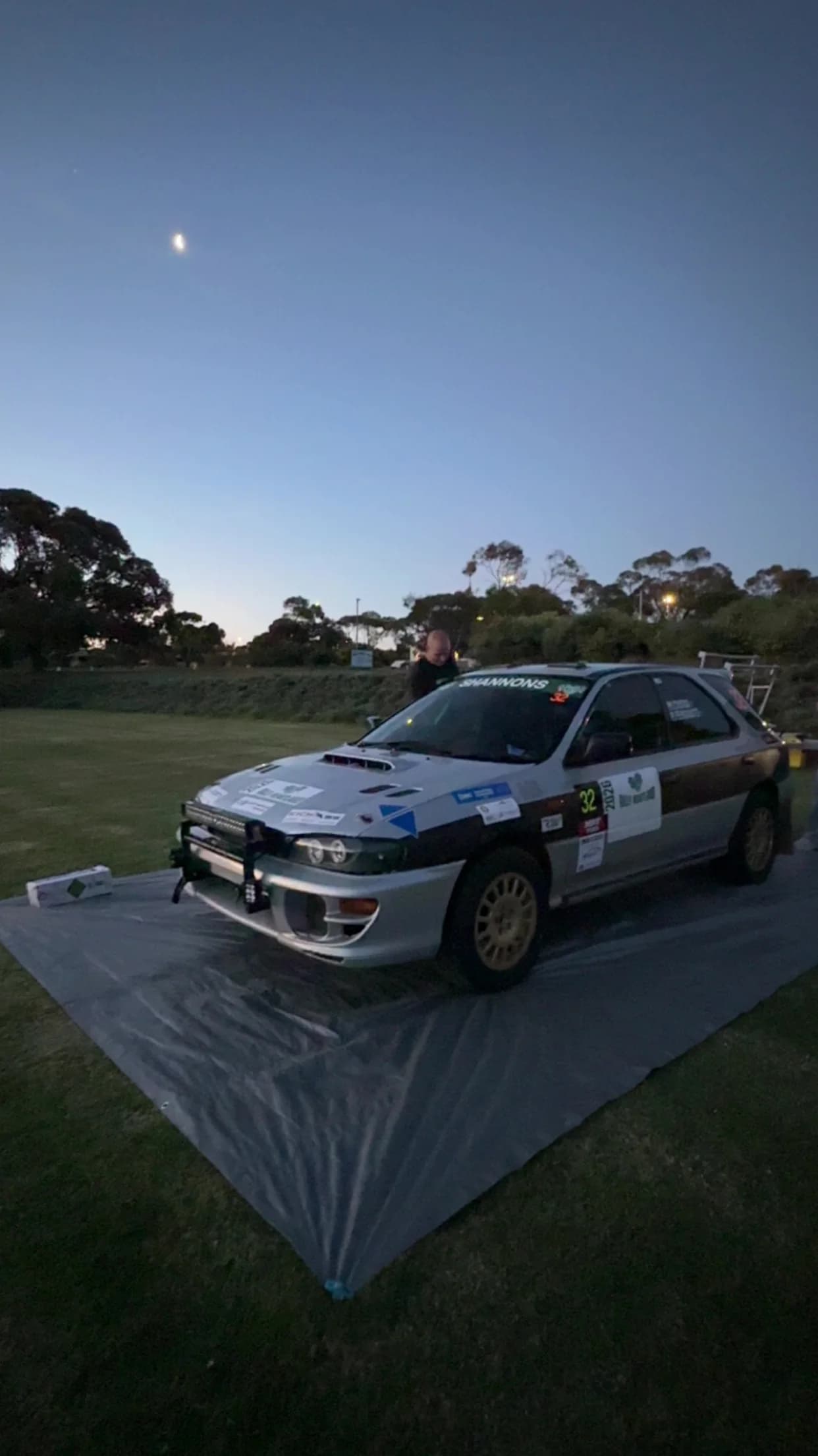 The Impreza under a rising moon at dusk at the Rally of the Heartland