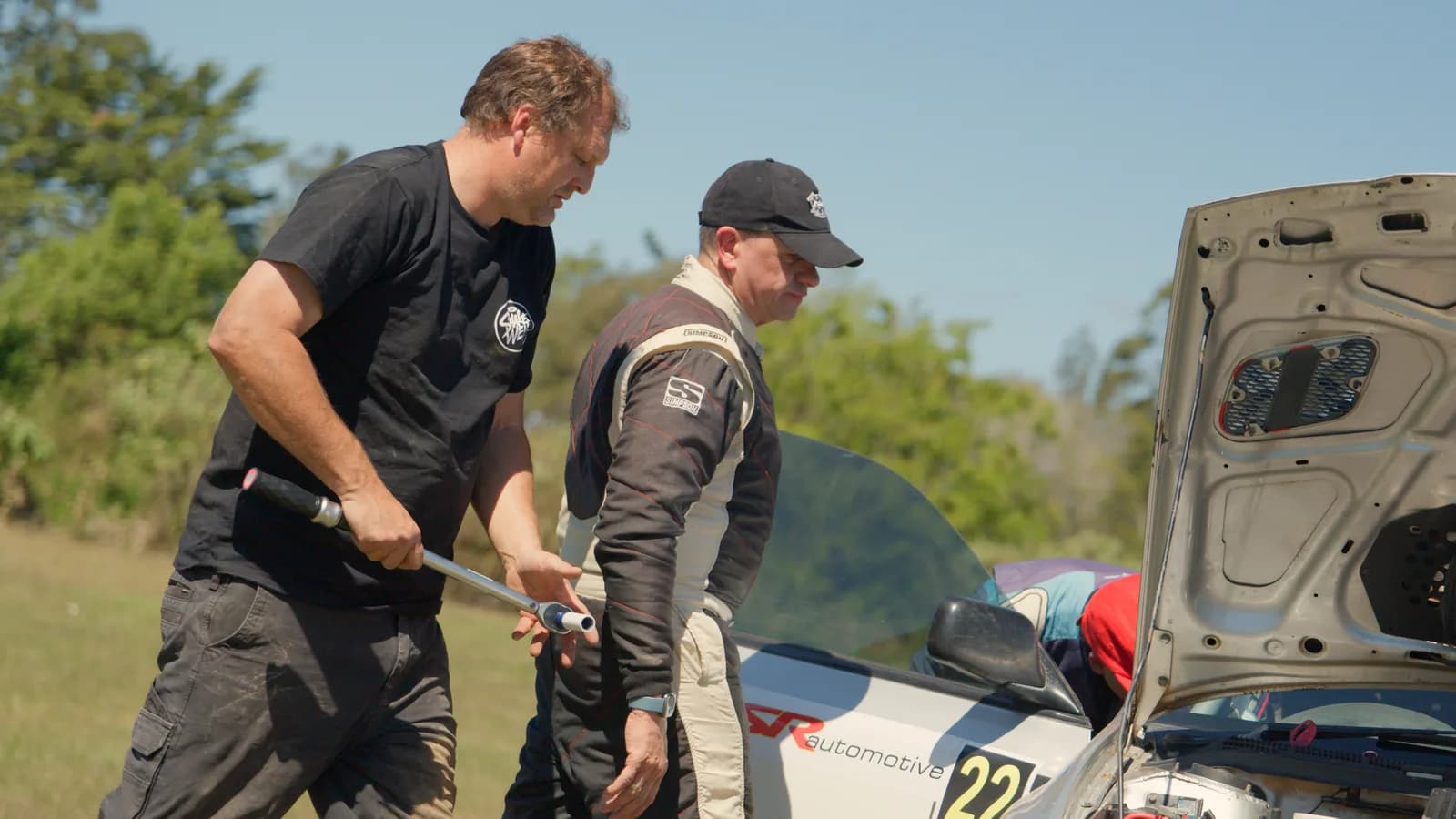 Crew working under the bonnet of car 22 at the Imbil Rally service park