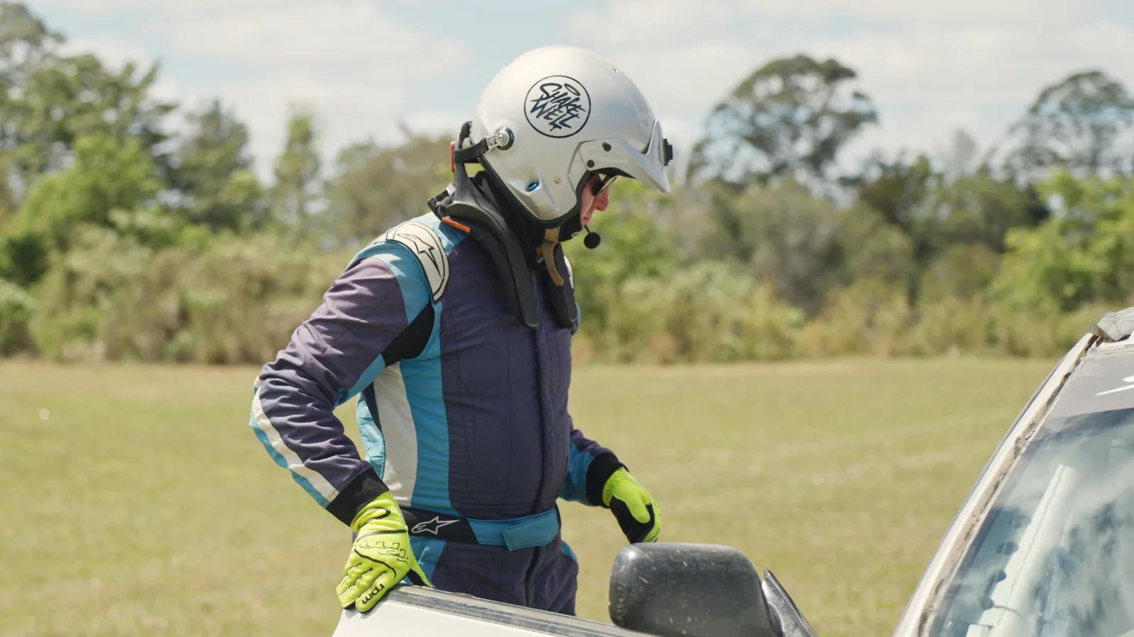 Pulling on a Shakewell Racing helmet beside the car at the Imbil Rally