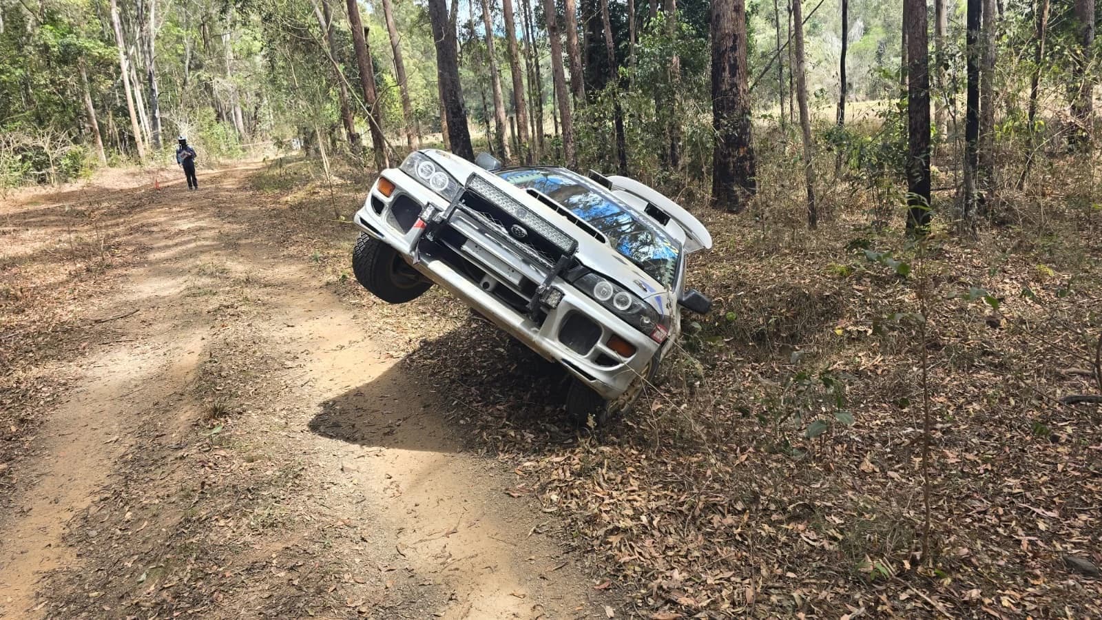 Car 22 off the road and up on a forest bank at the Imbil Rally