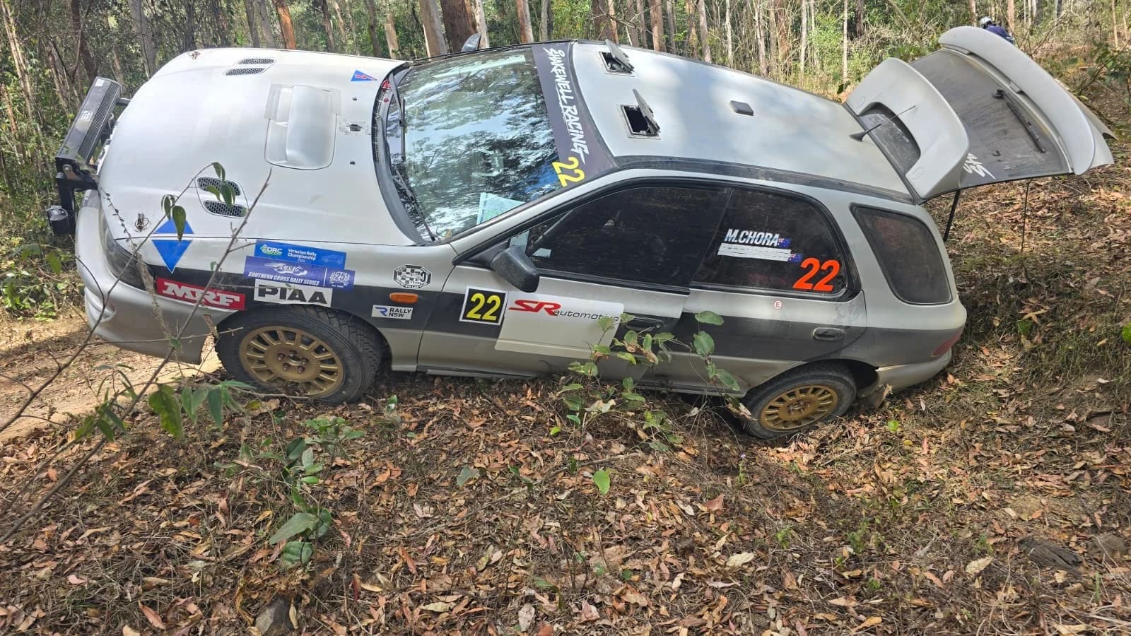 Car 22 beached in the leaf litter beside a forest road at the Imbil Rally
