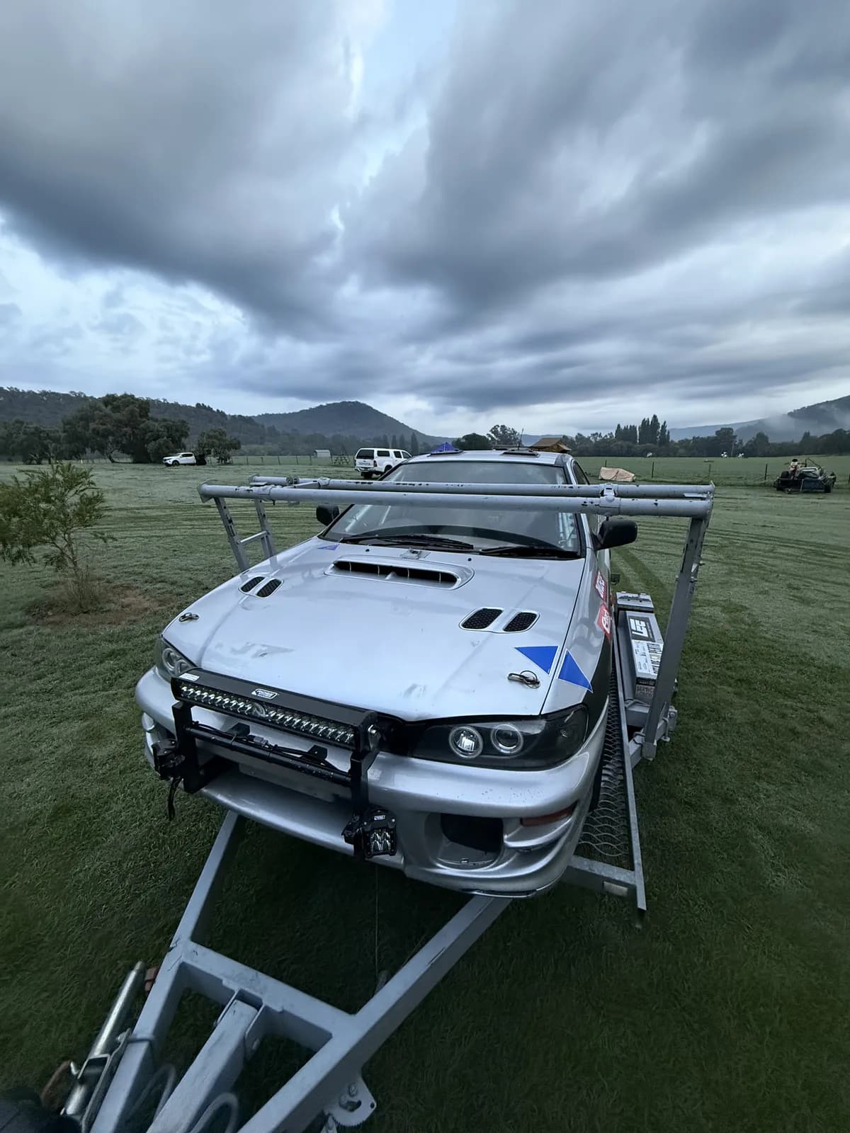 Rally car on the trailer under moody clouds before the Mitta Mountain Rally