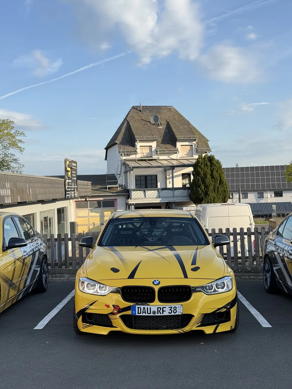A yellow BMW M4 parked in the village of Nürburg during Shakewell Racing's Nürburgring trip