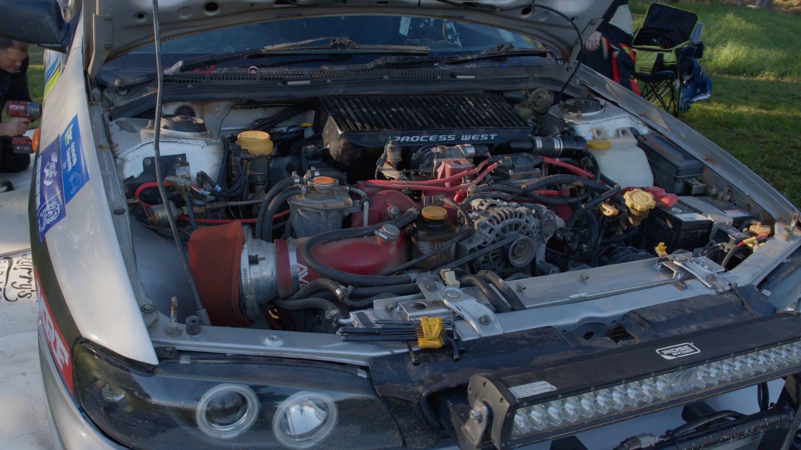 The open engine bay of the Shakewell Racing Impreza at service during the Narooma Forest Rally