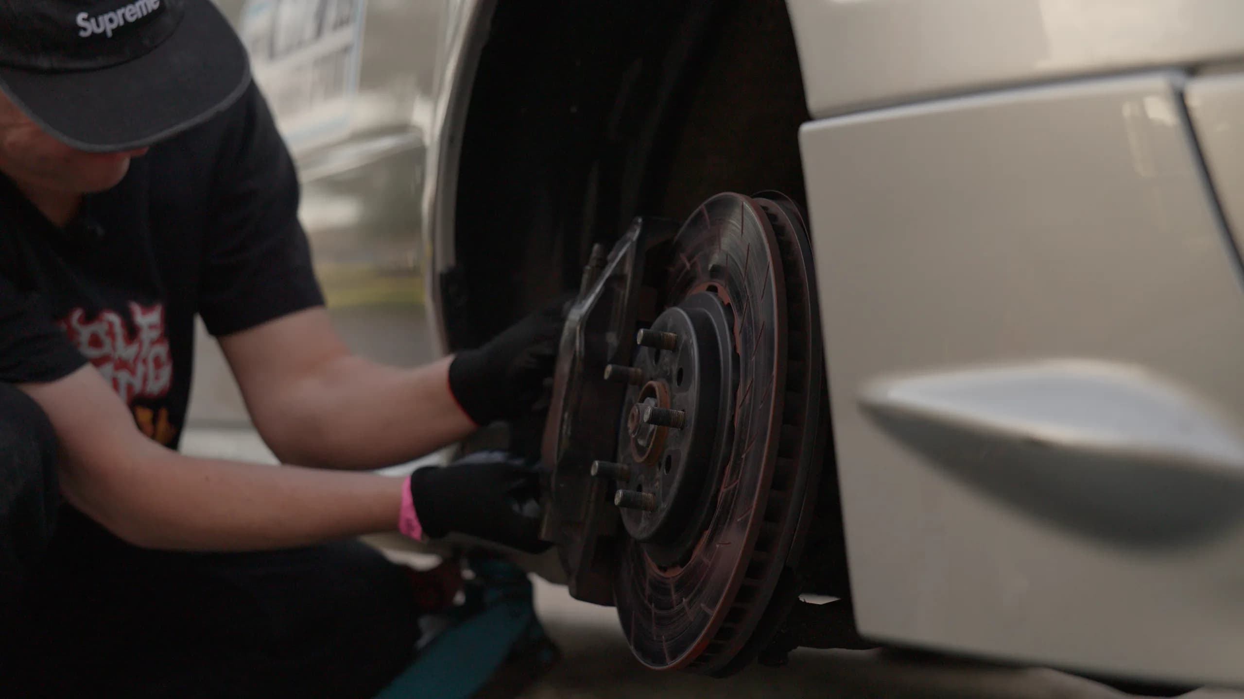 Working on the front brake and hub of the Shakewell Racing WRX STI at the Snowy River Sprint
